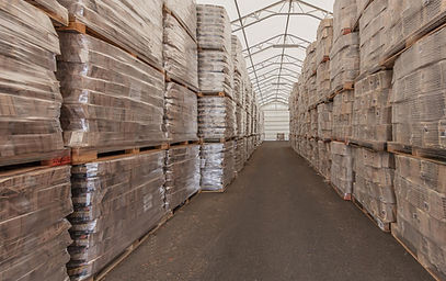 Covered warehouse with palletised wood fuel ready for dispatch